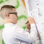 Student drawing on a whiteboard