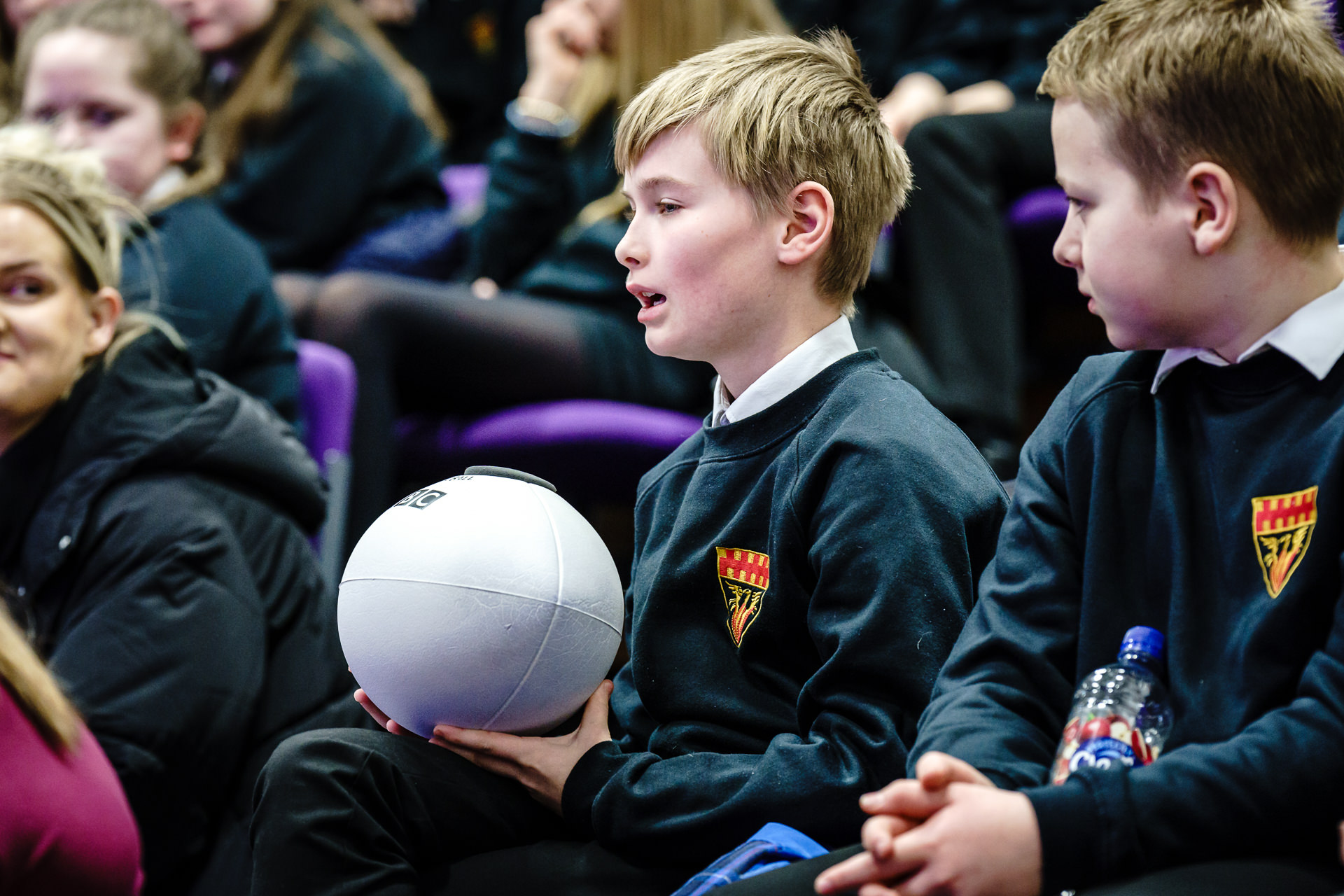 Students asking questions using mic'd up Rugby Ball!